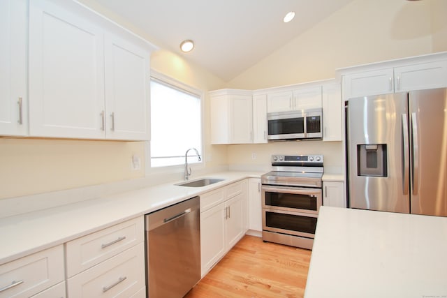 kitchen with white cabinetry, stainless steel appliances, and sink