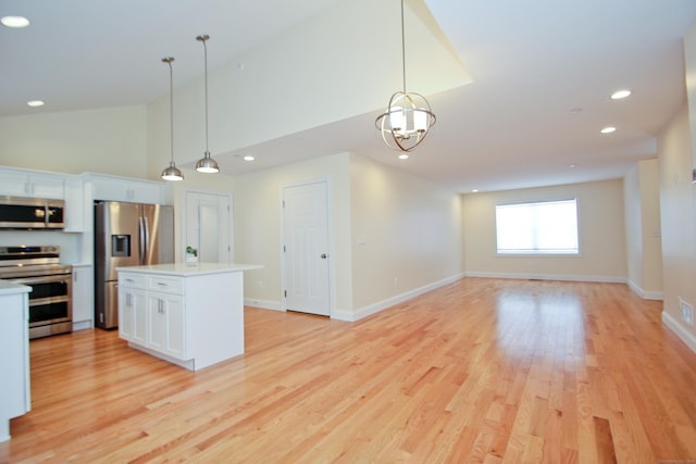 kitchen with white cabinetry, appliances with stainless steel finishes, a center island, and pendant lighting