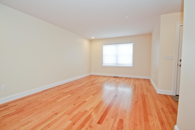 unfurnished room with light hardwood / wood-style floors