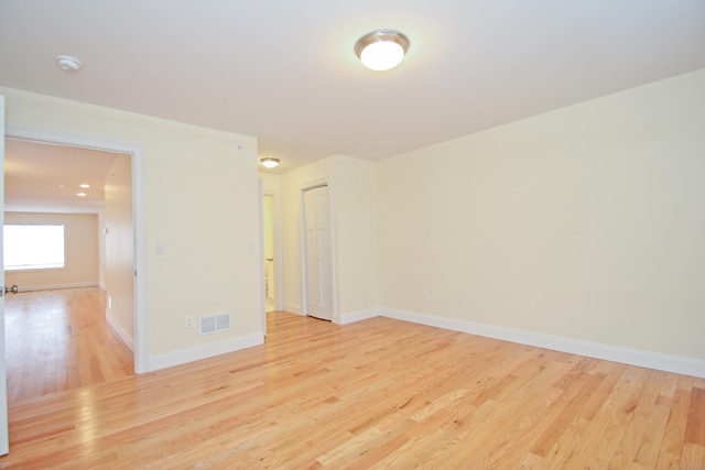 unfurnished room with light hardwood / wood-style floors