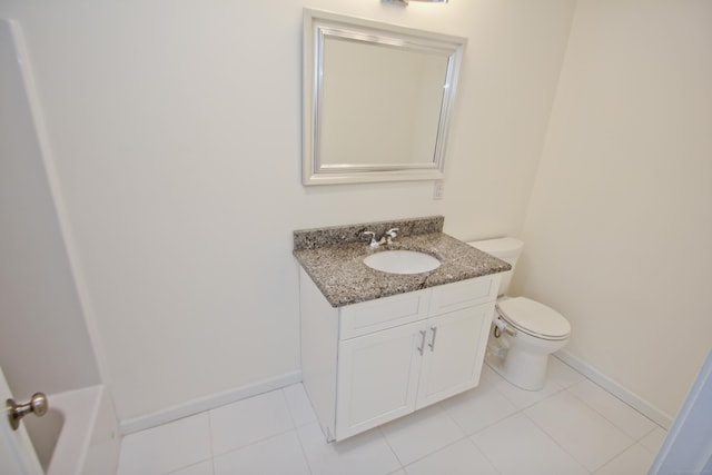 bathroom with vanity, tile patterned floors, and toilet