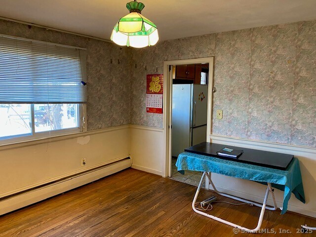 interior space featuring a baseboard radiator and hardwood / wood-style floors