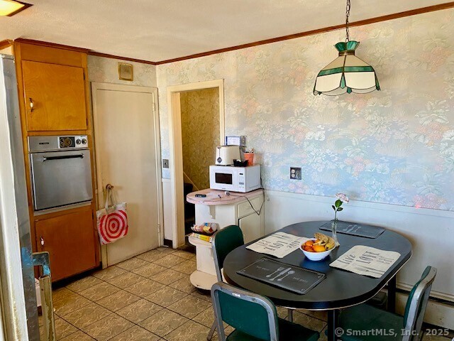 dining space with crown molding