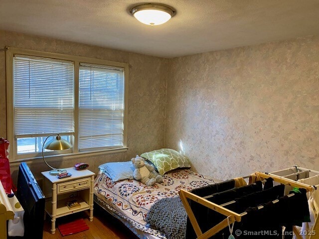 bedroom with wood-type flooring