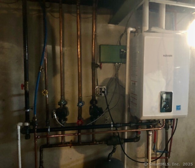 utility room featuring water heater