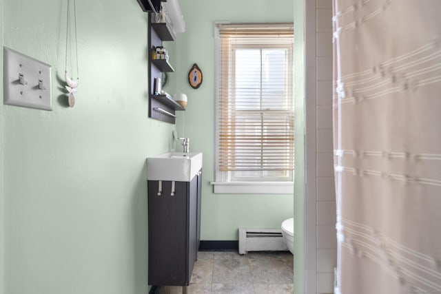 bathroom featuring a baseboard radiator, vanity, and toilet