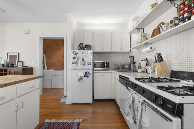 kitchen featuring tasteful backsplash, white appliances, dark hardwood / wood-style floors, and white cabinets