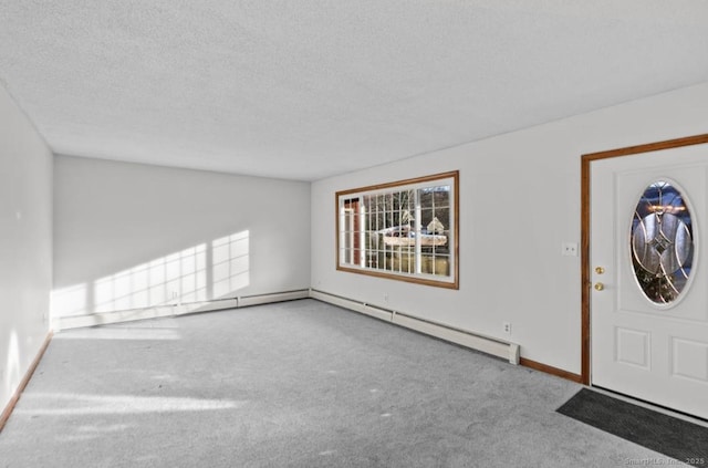 carpeted foyer featuring a textured ceiling