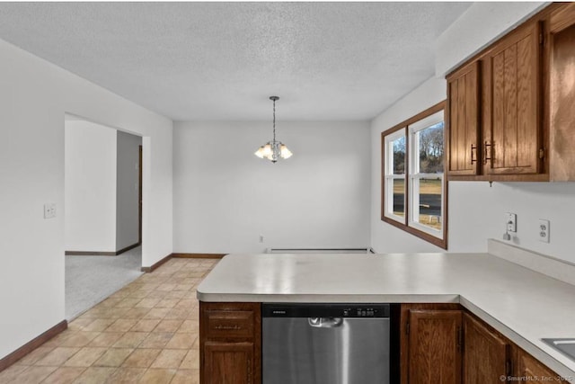 kitchen with a notable chandelier, a textured ceiling, decorative light fixtures, stainless steel dishwasher, and kitchen peninsula