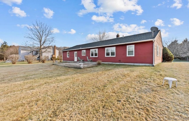 rear view of property with a yard and a patio