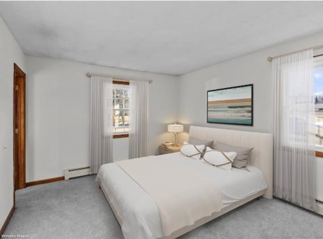 bedroom featuring a baseboard radiator and light colored carpet