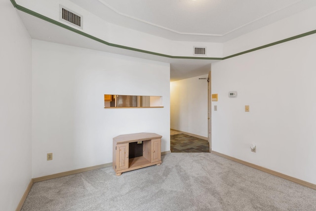 unfurnished living room featuring light carpet