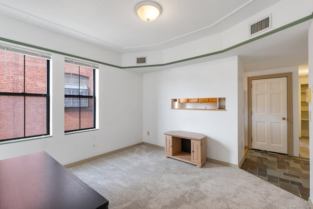 unfurnished living room featuring carpet flooring