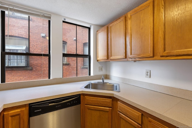 kitchen with dishwasher, plenty of natural light, sink, and a textured ceiling