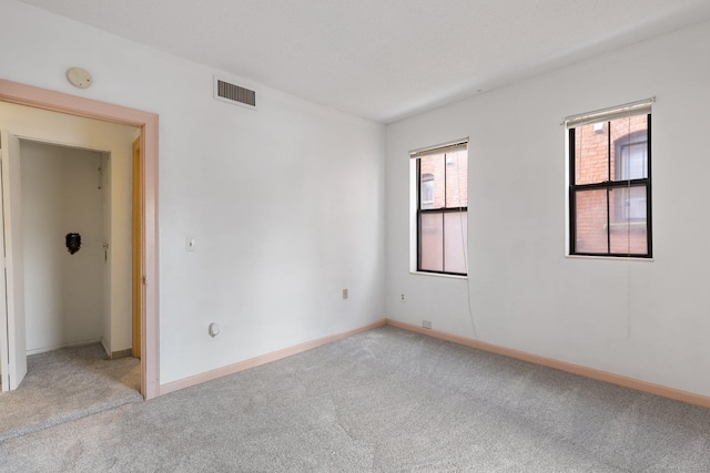 empty room featuring light carpet