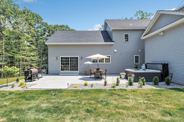 rear view of property featuring a hot tub, a patio, a yard, and cooling unit