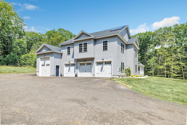 view of front facade with a garage and a front lawn