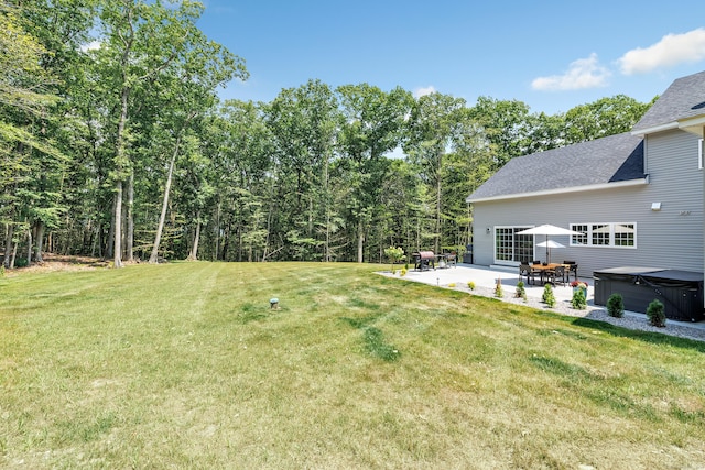 view of yard with a patio area and a hot tub