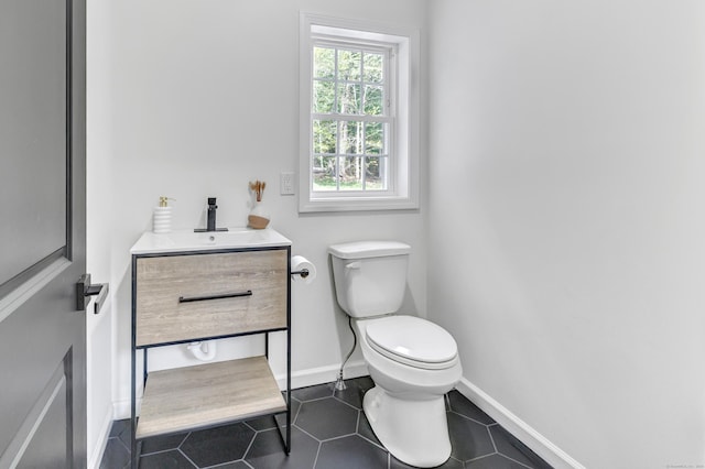 bathroom with vanity, toilet, and tile patterned flooring