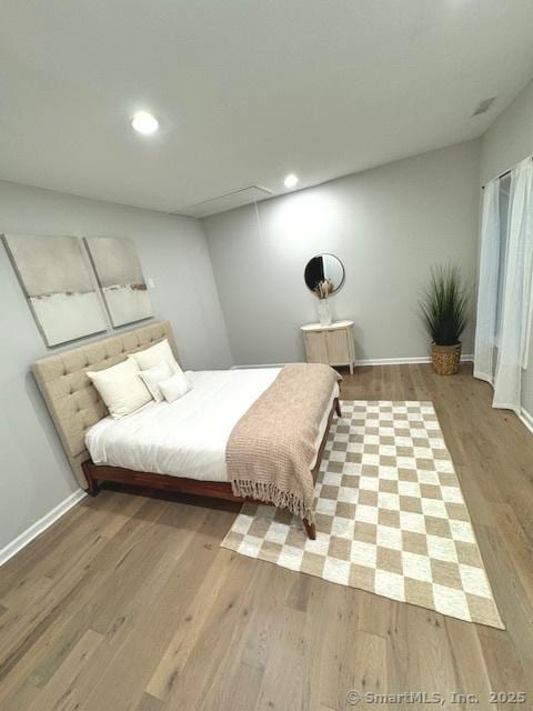 bedroom with hardwood / wood-style floors