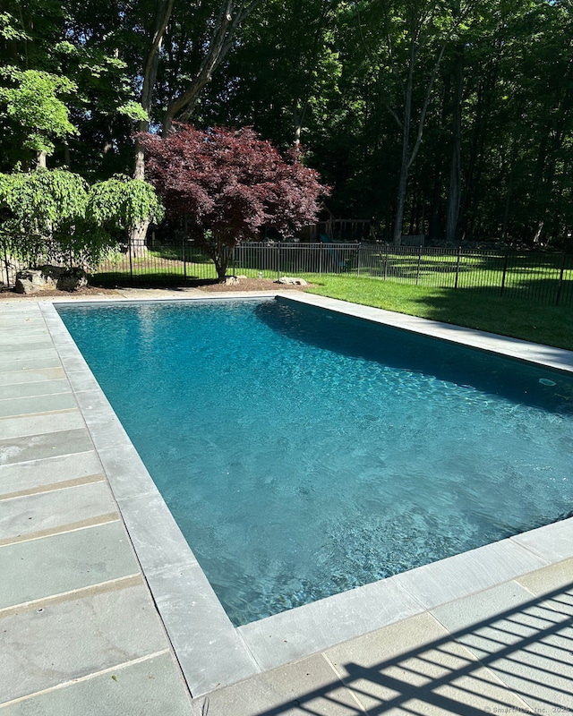 view of pool with a lawn, fence, and a fenced in pool