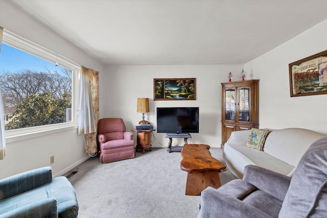 carpeted living area featuring baseboards