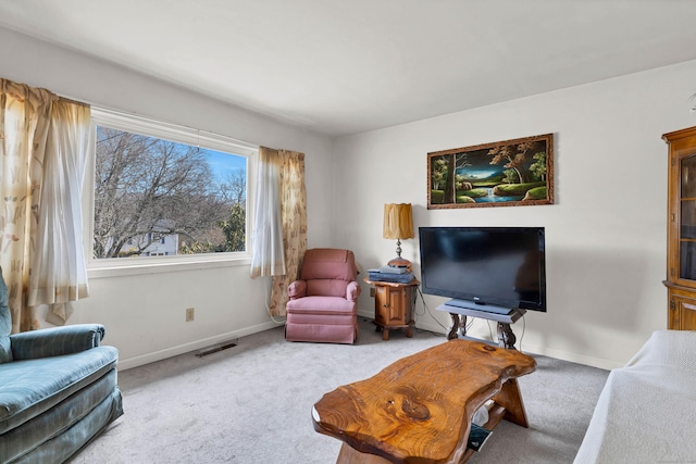 living area with carpet, visible vents, and baseboards