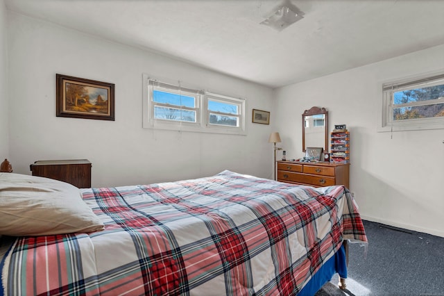 carpeted bedroom featuring baseboards