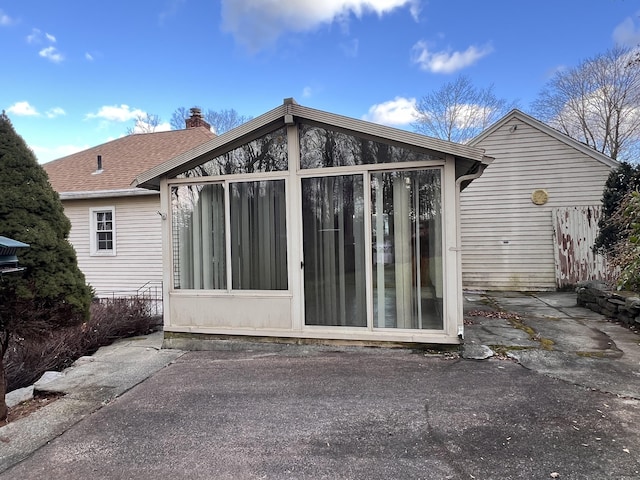 back of house featuring a sunroom