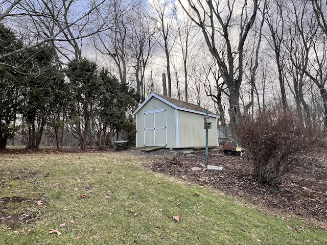 view of outbuilding featuring a lawn