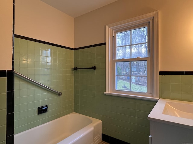 bathroom featuring tile walls, vanity, and a tub