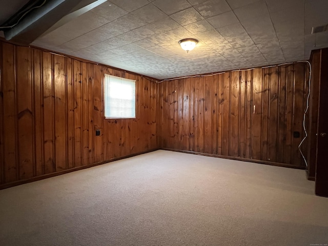 basement featuring carpet floors and wooden walls