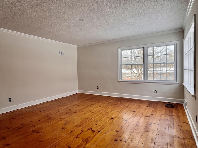 unfurnished room with crown molding, a textured ceiling, and light hardwood / wood-style floors