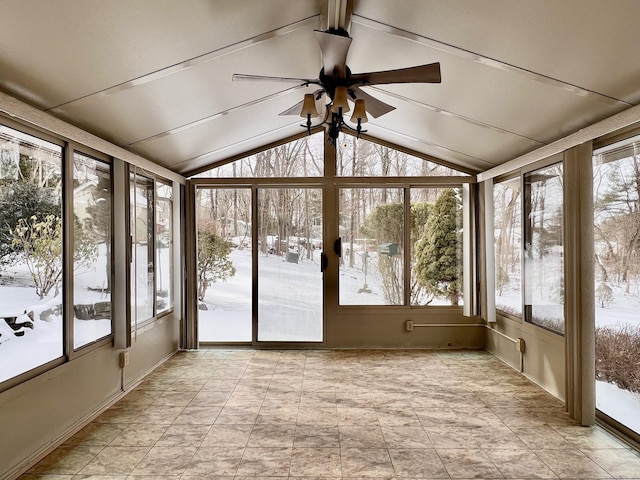 unfurnished sunroom featuring a wealth of natural light, vaulted ceiling, and ceiling fan