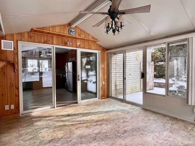 interior space featuring lofted ceiling with beams and ceiling fan