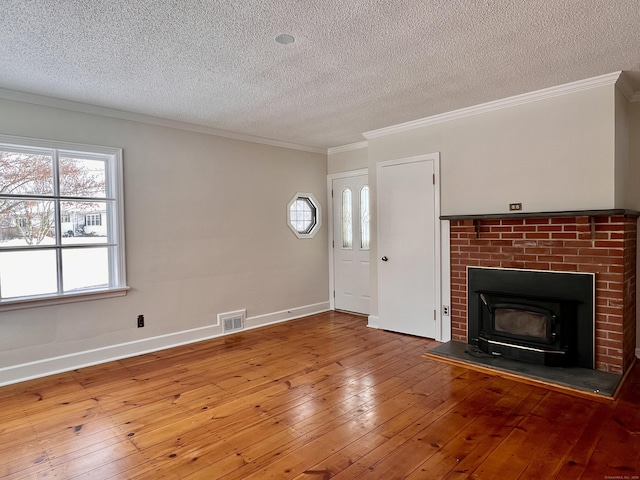 unfurnished living room featuring hardwood / wood-style flooring, ornamental molding, and a textured ceiling