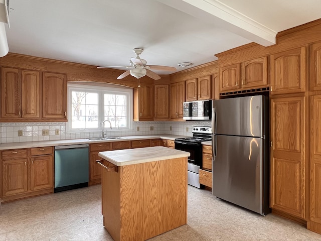 kitchen featuring sink, appliances with stainless steel finishes, backsplash, beam ceiling, and a center island