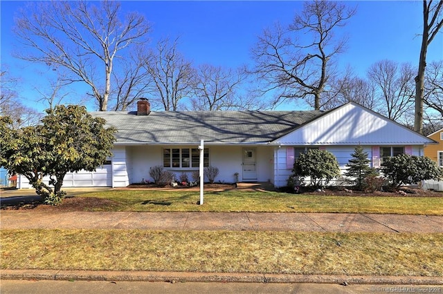 ranch-style home with a garage and a front yard