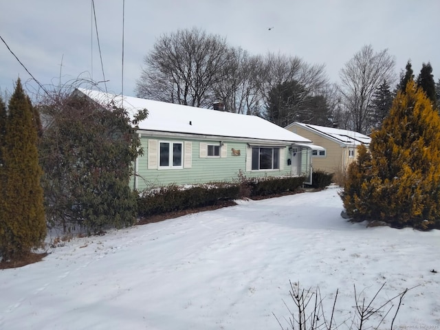 view of snow covered rear of property