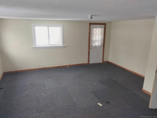 spare room with a textured ceiling