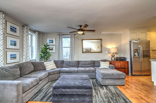 living room featuring ceiling fan and wood-type flooring