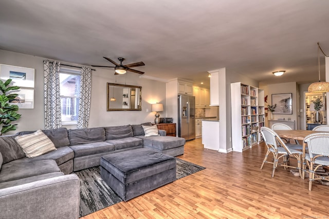 living room with light hardwood / wood-style floors and ceiling fan