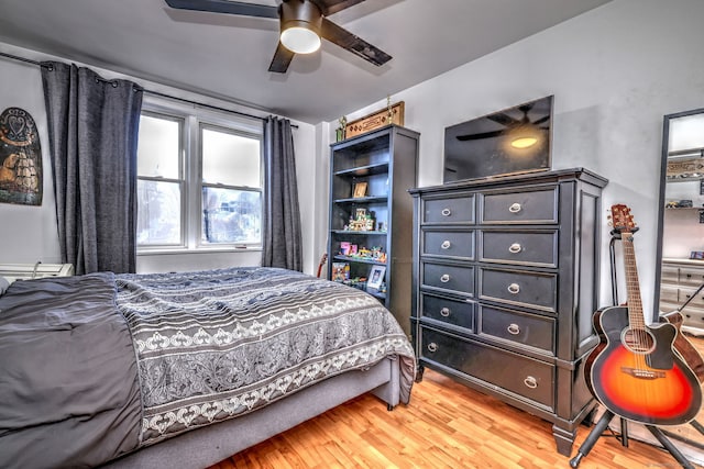 bedroom featuring hardwood / wood-style flooring and ceiling fan