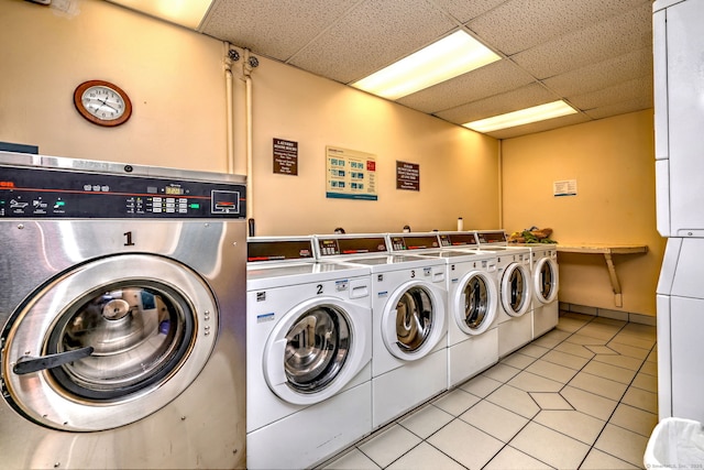 laundry area featuring light tile patterned floors and washer and dryer