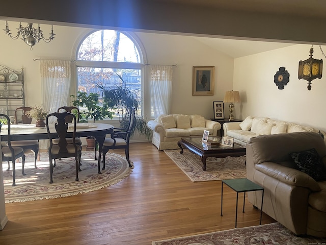 living room featuring vaulted ceiling and hardwood / wood-style floors