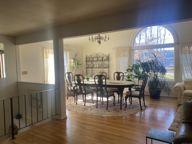 dining room with hardwood / wood-style flooring and a chandelier