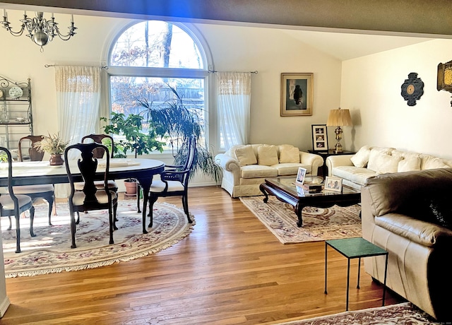 living room with hardwood / wood-style flooring and vaulted ceiling