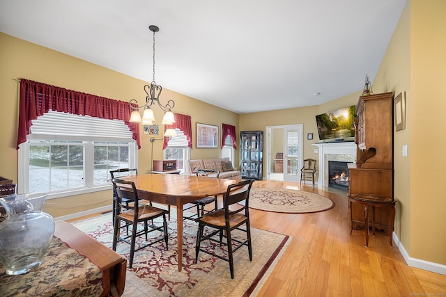 dining room with a chandelier and light wood-type flooring