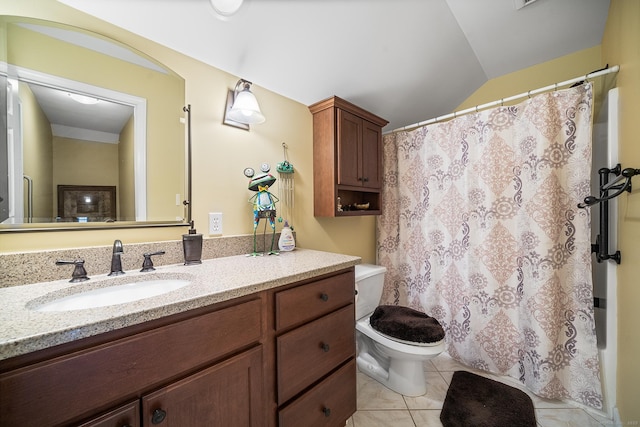 bathroom with vanity, tile patterned flooring, lofted ceiling, and toilet