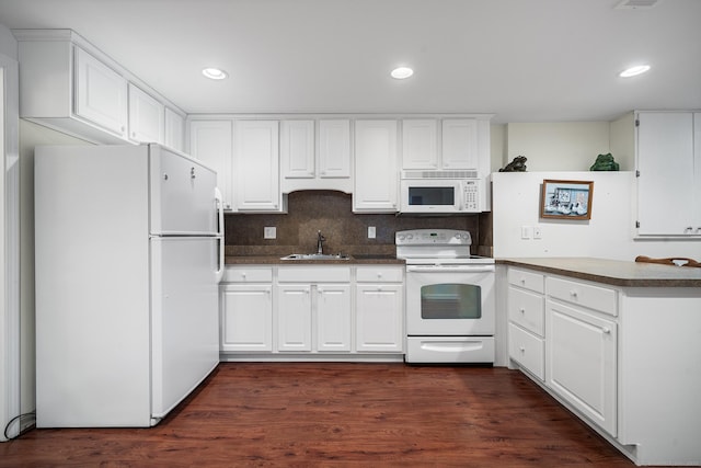 kitchen with white appliances, dark hardwood / wood-style flooring, sink, and white cabinets